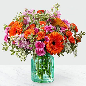 Orange and Pink Mixed Flowers in a Blue Vase